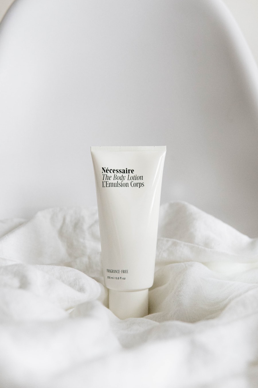 A skincare tube resting on white linen