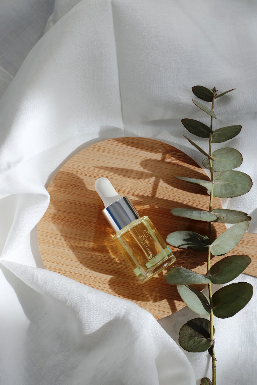 A serum bottle in sunlight on wood and linen